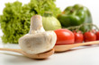 fresh champignon and tomato on wooden spoon
