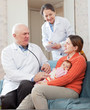doctor talks with mother of newborn baby