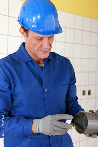 Photo: plumber changing a pipe plumber changing a pipe