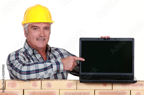Photo: Manual worker with computer Manual worker with computer