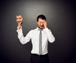 crying man holding mask