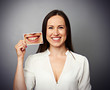 Photo: woman holding picture with yellow teeth woman holding picture with yellow teeth