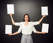 Photo: woman with four hands holding white boards woman with four hands holding white boards