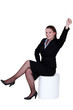 Photo: Businesswoman reaching into the air Businesswoman reaching into the air