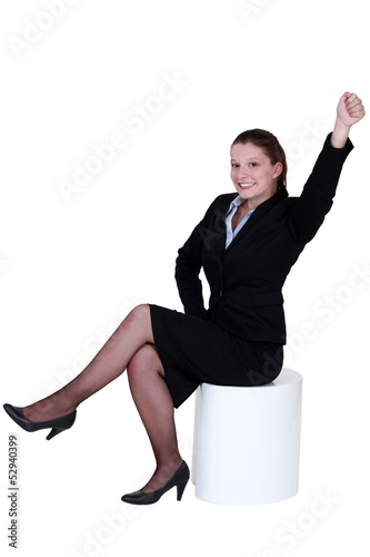 Photo: Businesswoman reaching into the air Businesswoman reaching into the air