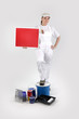 Photo: Female decorator stood with red poster Female decorator stood with red poster