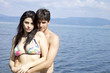 Beautiful couple in swimwear looking and smiling