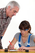 Foto: Man supervising his assistant Man supervising his assistant