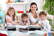 Photo: three primary schoolgirls and a teacher three primary schoolgirls and a teacher
