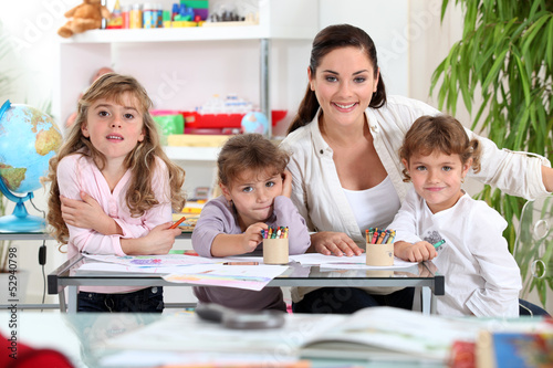 Photo: three primary schoolgirls and a teacher three primary schoolgirls and a teacher