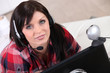 Photo: a woman communicating through a webcam a woman communicating through a webcam