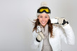 Cheerful skier woman showing ski pass