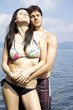 Two beautiful model in the sea getting tanned in love