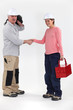 Foto: Manual workers greeting each other Manual workers greeting each other