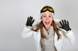 Happy woman in ski outfit showing hands up