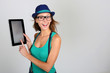 Photo: Funny trendy girl showing tablet screen Funny trendy girl showing tablet screen