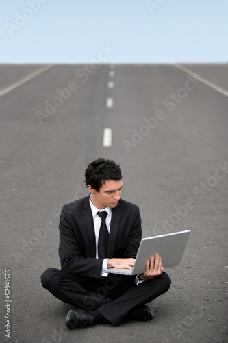 Photo: Businessman sat on road Businessman sat on road