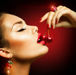 Sexy Woman Eating Cherry. Sensual red Lips with Cherries