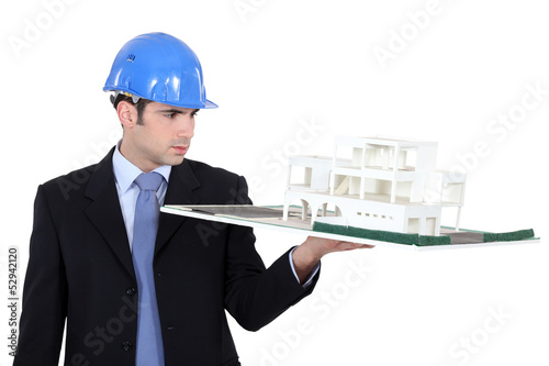 Photo: Man holding model housing Man holding model housing