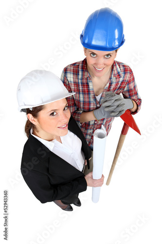 Photo: high angle shot of female architect and female bricklayer high angle shot of female architect and female bricklayer