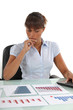 A businesswoman checking prognostic charts.