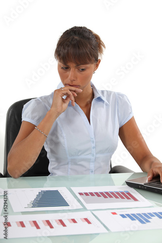 Photo: A businesswoman checking prognostic charts. A businesswoman checking prognostic charts.
