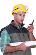 Photo: Young foreman using radio to communicate Young foreman using radio to communicate