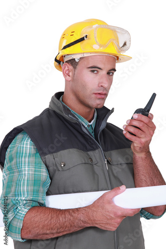Photo: Young foreman using radio to communicate Young foreman using radio to communicate