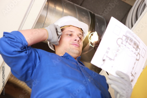 Photo: Plumber looking at plans Plumber looking at plans
