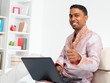 Photo: Indian man using computer at home. Indian man using computer at home.