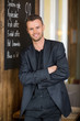 Businessman Standing Arms Crossed In Coffeeshop