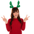Photo: Asian Christmas girl showing victory sign. Asian Christmas girl showing victory sign.