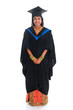 Full body happy Indian university student in graduation gown
