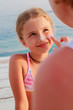 Sun protection-mother anoints her daughter face protective cream