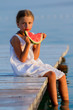 Summer joy, lovely girl eating fresh watermelon on the beach