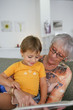 Photo: Young child reading with grandma Young child reading with grandma