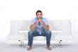 Foto: beautiful young man sitting on the sofa beautiful young man sitting on the sofa