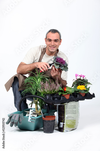 Photo: Gardener knelt by plants Gardener knelt by plants