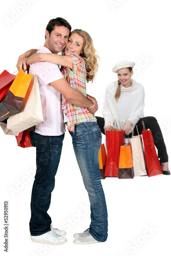 Photo: Three people with shopping bags Three people with shopping bags