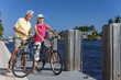 Happy Senior Couple on Bicycles By a River