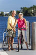 Happy Senior Couple on Bicycles By a River or Sea