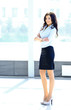 Photo: A portrait of a young business woman in an office A portrait of a young business woman in an office