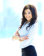 Photo: A portrait of a young business woman in an office A portrait of a young business woman in an office