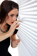 Woman peering through venetian blinds