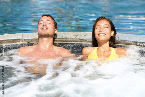 Photo: Spa couple relaxing enjoying jacuzzi hot tub Spa couple relaxing enjoying jacuzzi hot tub