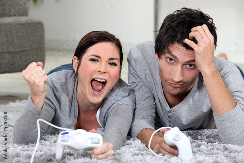 Photo: a couple playing video games a couple playing video games
