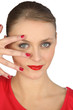 Woman spreading her fingers over her face