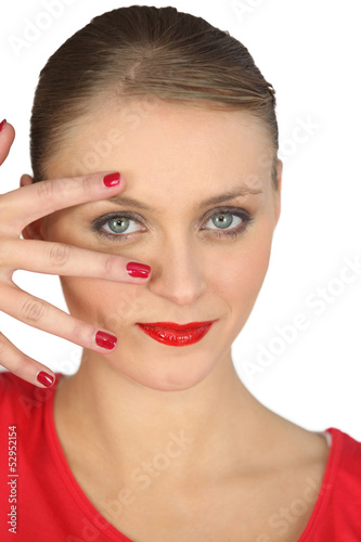 Photo: Woman spreading her fingers over her face Woman spreading her fingers over her face