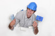 Photo: A male construction worker with cash and a European flag. A male construction worker with cash and a European flag.