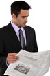 Businessman reading a newspaper
